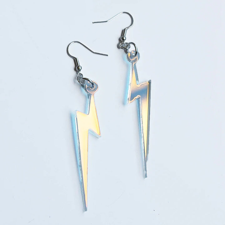 Pair of lightning bolt earrings on a light gray background