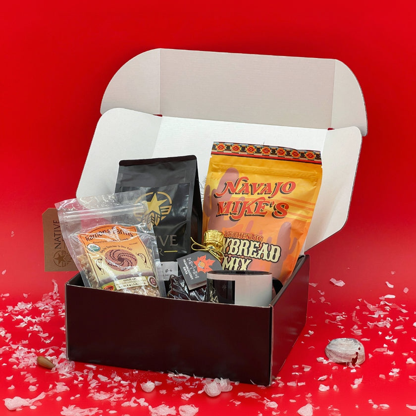 black box with a white interior containing various items including a book and a black bag.