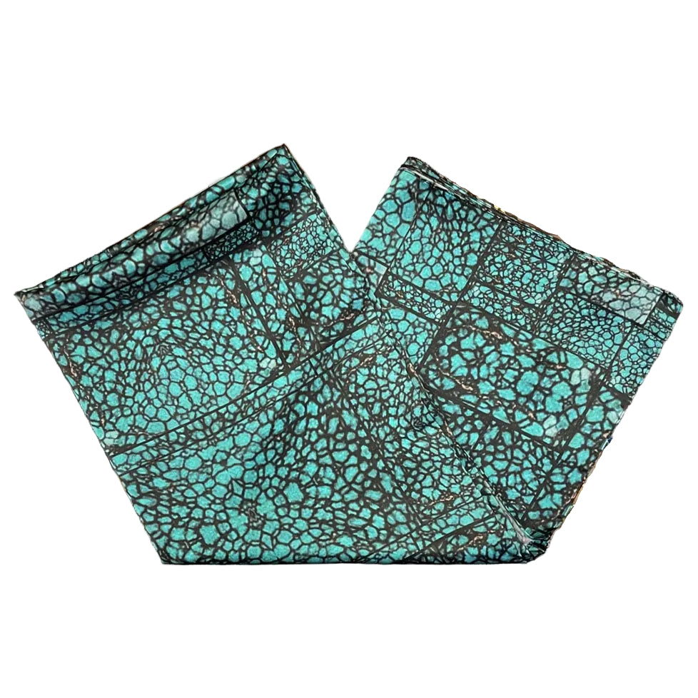Turquoise patterned scarf on a white background