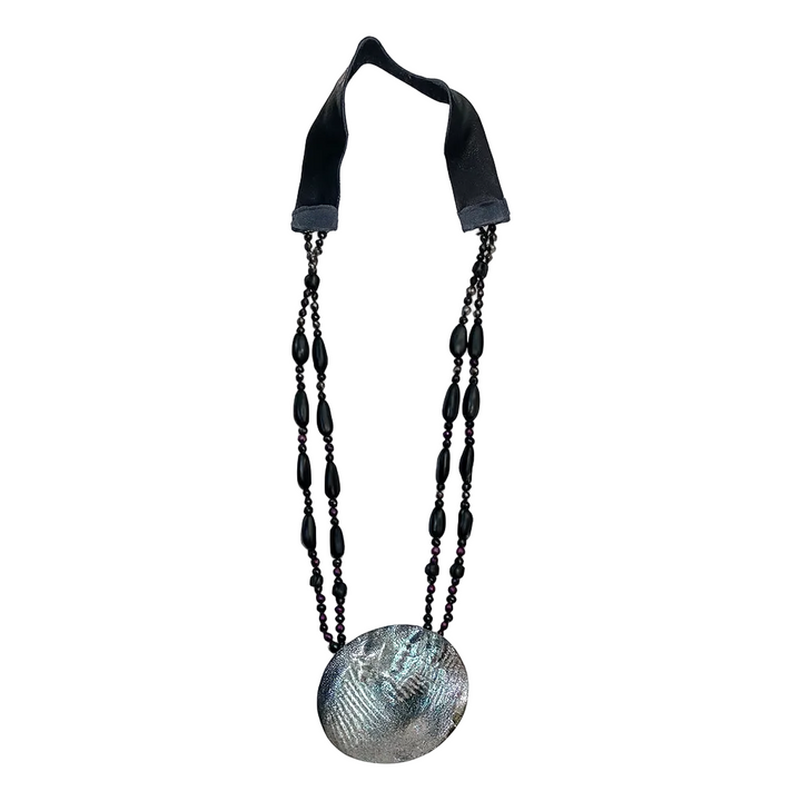 Necklace with a large round shell pendant on a white background