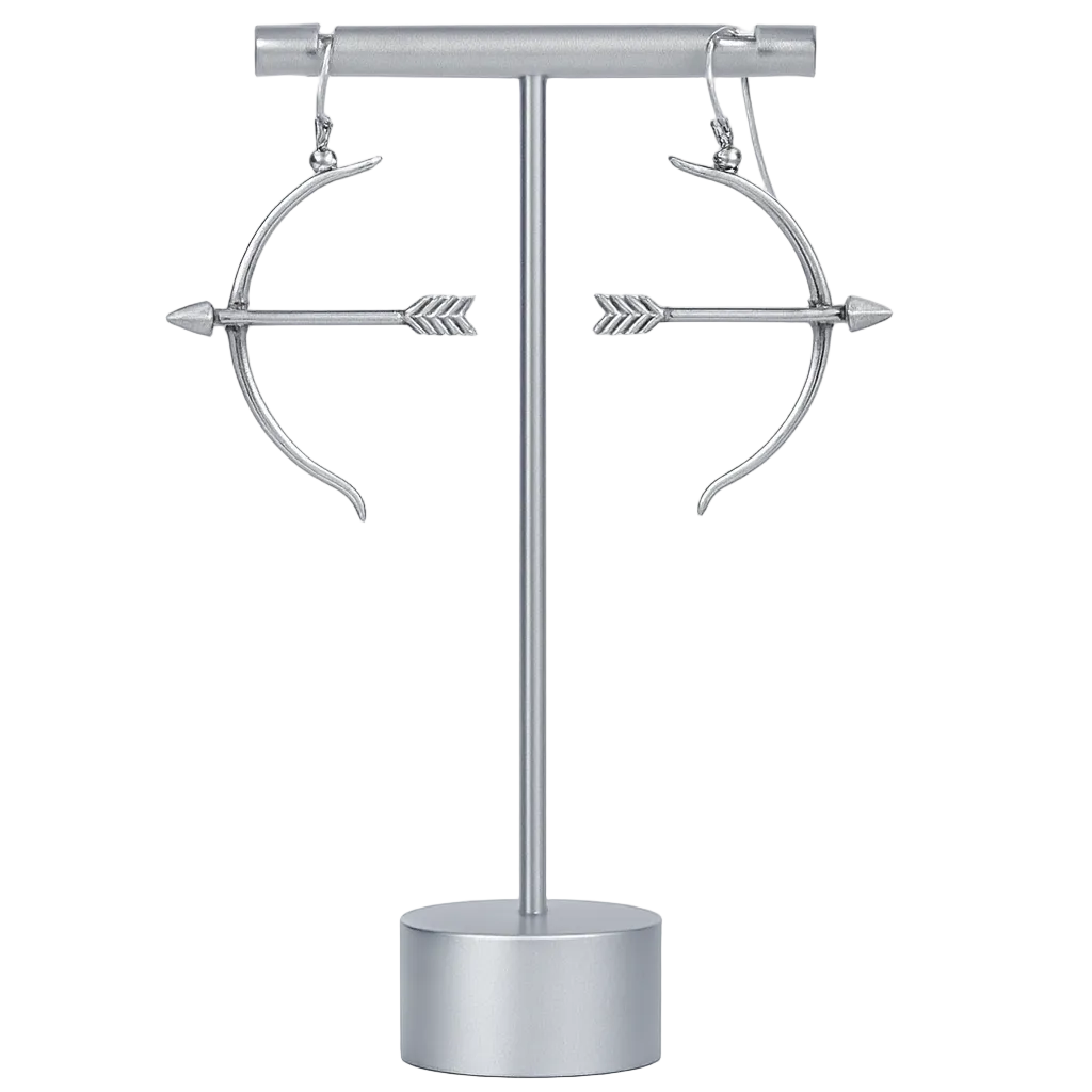 Silver bow and arrow earrings on a stand against a white background