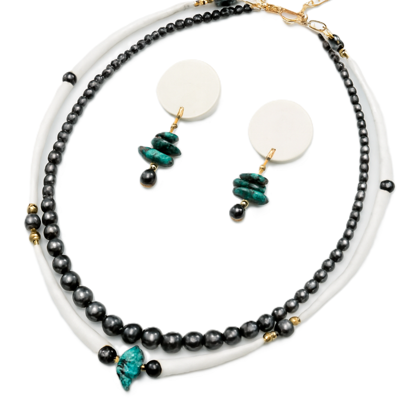 Jewelry set with black beaded necklace and earrings on a white background