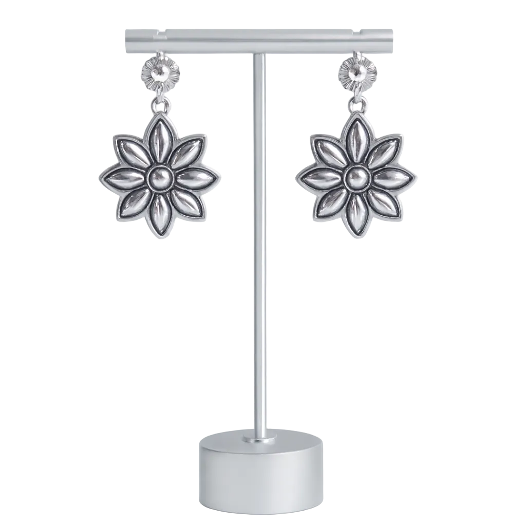 Silver flower-shaped earrings on a display stand against a white background